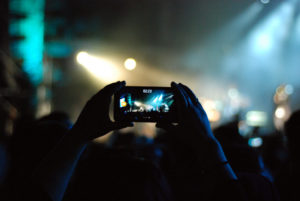 Person films concert with cell phone