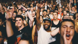 Man raising his hand in a crowd